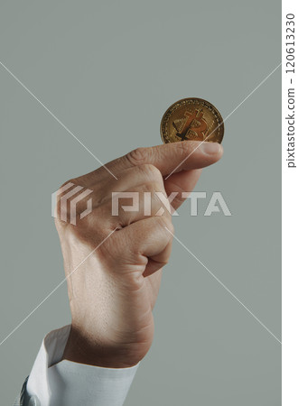 businessman with a bitcoin in his hand 120613230