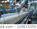 Selective focus of A robot arm in a dairy factory is picking up a stack of white glass bottles filled with fresh pasteurized milk. 120613350