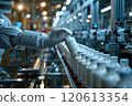 Selective focus of A robot arm in a dairy factory is picking up a stack of white glass bottles filled with fresh pasteurized milk. 120613354