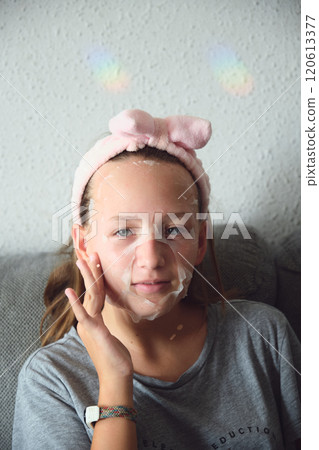 girl with a cosmetic mask on her face 120613377