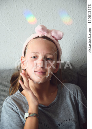 girl with a cosmetic mask on her face girl with a cosmetic mask on her face 120613378
