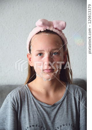girl with a cosmetic mask on her face 120613379