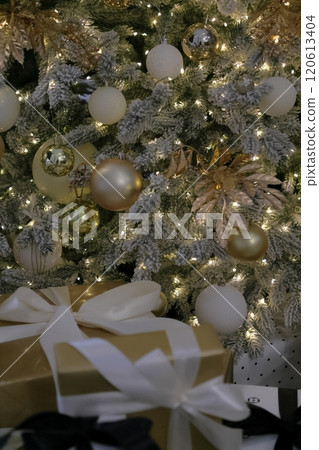close-up Christmas tree with garland and toys. New Year's decor, gift box on Christmas Eve. 120613404