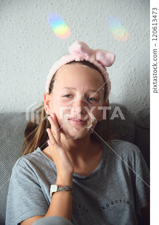 girl with a cosmetic mask on her face girl with a cosmetic mask on her face 120613473