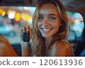 Caucasian woman showing car keys in hand sitting inside car in showroom. 120613936