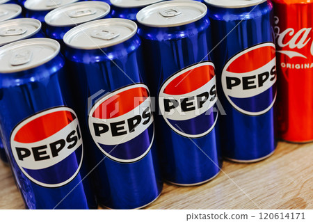 Kyiv, Ukraine - November 5, 2024: Close-up of neatly arranged Pepsi and Coca-Cola cans, showcasing a vibrant contrast of their iconic blue and red branding Kyiv, Ukraine - November 5, 2024: Close-up of neatly arranged Pepsi and Coca-Cola cans, showcasing a vibrant contrast of their iconic blue and red branding 120614171