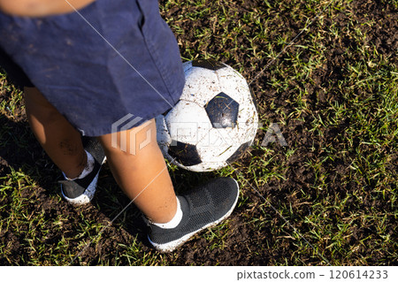 Outdoors, Playing soccer on grass field, african american boy wearing shorts and sneakers in school Outdoors, Playing soccer on grass field, african american boy wearing shorts and sneakers in school 120614233