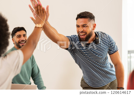 Celebrating success, young friends high-fiving and smiling in casual setting, start up business Celebrating success, young friends high-fiving and smiling in casual setting, start up business 120614617