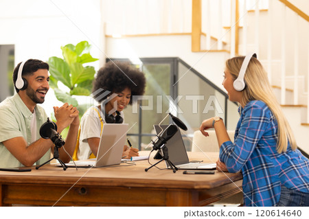 Recording podcast, friends using microphones and headphones, enjoying conversation Recording podcast, friends using microphones and headphones, enjoying conversation 120614640