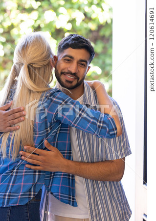 Friends hugging warmly, greeting each other with smiles and joy 120614691