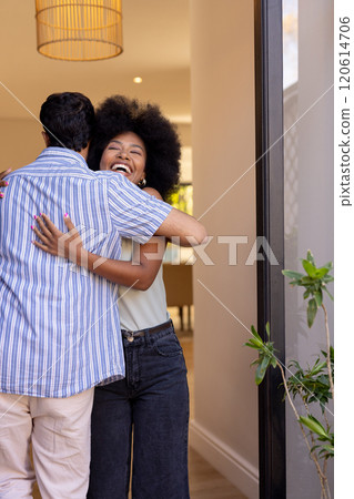 Hugging and smiling, young friends greeting each other warmly at home 120614706