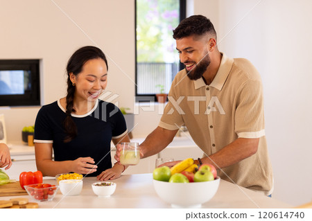 Friends in kitchen, enjoying drinks and preparing healthy meal together Friends in kitchen, enjoying drinks and preparing healthy meal together 120614740