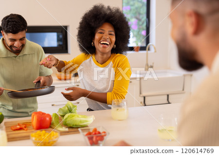 Cooking together, diverse friends laughing and enjoying time in modern kitchen Cooking together, diverse friends laughing and enjoying time in modern kitchen 120614769