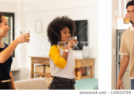 Socializing and having fun, diverse friends enjoying drinks together indoors Socializing and having fun, diverse friends enjoying drinks together indoors 120614789