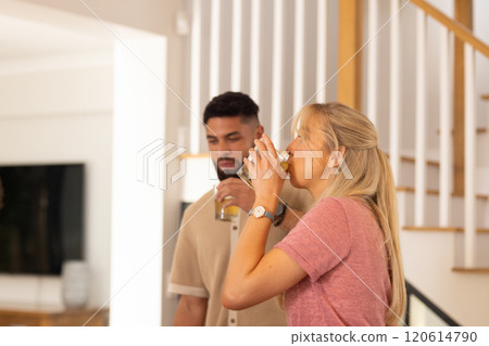 Drinking juice, young diverse friends enjoying time together in modern home, copy space 120614790