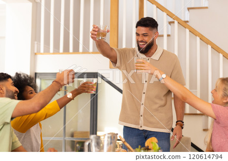 Toasting with drinks, diverse friends celebrating together in cheerful gathering 120614794