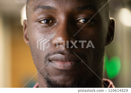 Close-up of african american man looking confidently at camera in professional business setting 120614829