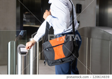 Scanning ID card, business professional entering office building with shoulder bag Scanning ID card, business professional entering office building with shoulder bag 120614839