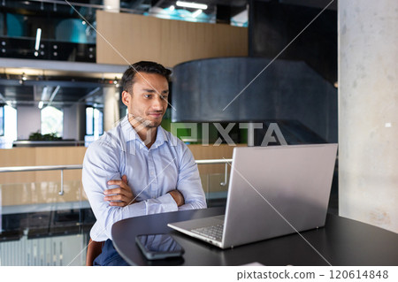 Working on laptop, businessman in modern office focusing on screen, copy space 120614848