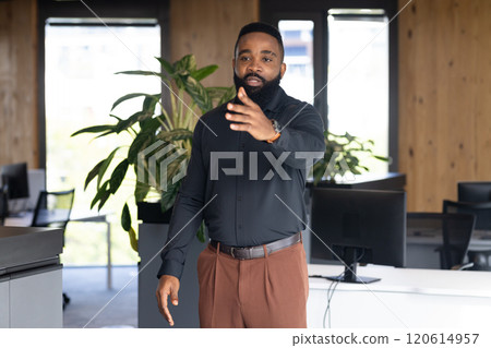 Gesturing while discussing project with colleagues, African American businessman in office Gesturing while discussing project with colleagues, African American businessman in office 120614957