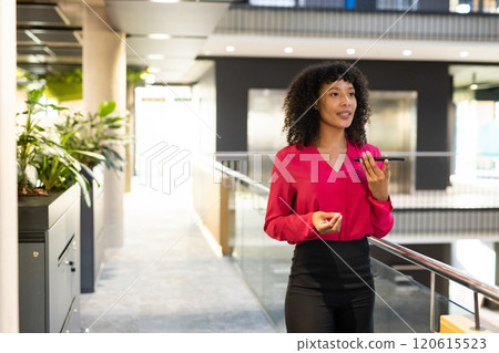 Speaking on smartphone, businesswoman walking in modern office building hallway, copy space Speaking on smartphone, businesswoman walking in modern office building hallway, copy space 120615523