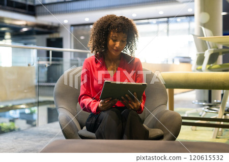 Using tablet, businesswoman sitting in modern office, working on project Using tablet, businesswoman sitting in modern office, working on project 120615532