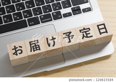 A building block with the expected delivery date written on it 120615584