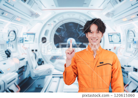 Young male astronaut working inside the space station 120615860