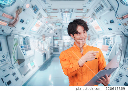 Young male astronaut working inside the space station 120615869