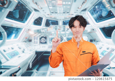 Young male astronaut working inside the space station 120615875