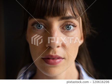 Close-up of woman with blue eyes and bangs, looking directly at camera Close-up of woman with blue eyes and bangs, looking directly at camera 120616206