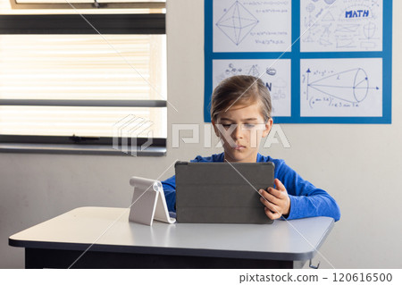 In school, boy using tablet for studying math in classroom 120616500