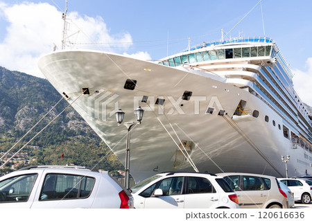 A large cruise liner docked at the pier against the backdrop of a mountain landscape. Aesthetics of scale. 120616636