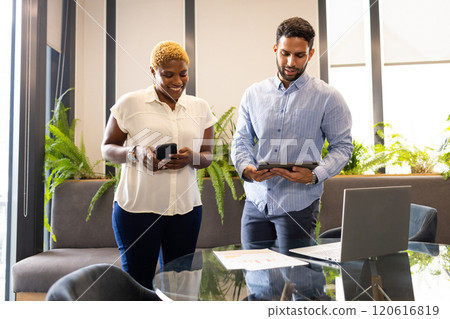 Collaborating in modern office, business colleagues using smartphone and tablet 120616819