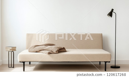 This sofa bed combines minimalism and comfort, with a fluffy blanket and lamp for hosting guests 120617268