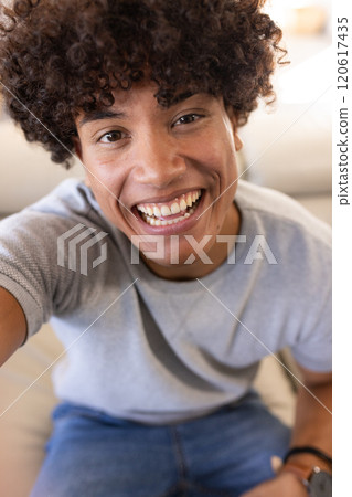 On video call, Smiling young man, enjoying moment, at home 120617435