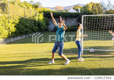 Playing soccer, boy celebrating goal with friends on outdoor field, copy space Playing soccer, boy celebrating goal with friends on outdoor field, copy space 120617568