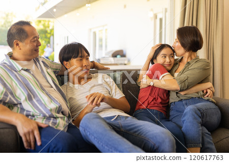 Relaxing on couch, happy family bonding and spending quality time together 120617763
