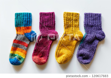 Homemade warm winter colorful striped knitted socks. Set of different knitting socks from woolen threads. Homemade warm winter colorful striped knitted socks. Set of different knitting socks from woolen threads. 120617883