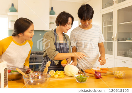 Cooking together, multiracial family preparing vegetables in kitchen, enjoying time together 120618105