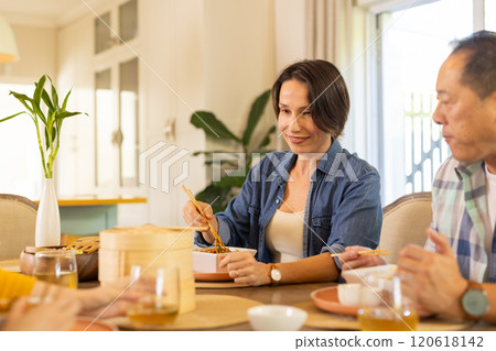 At home, Eating together, asian family enjoying meal with chopsticks at dining table At home, Eating together, asian family enjoying meal with chopsticks at dining table 120618142