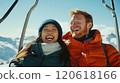 Joyful couple on a ski lift enjoying a winter adventure in the mountains 120618166