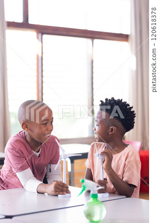 In school, two african american boys discussing wind turbine models in classroom In school, two african american boys discussing wind turbine models in classroom 120618378