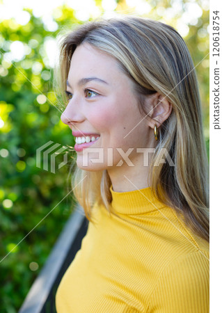 Happy caucasian woman standing on balcony and looking ahead, copy space 120618754
