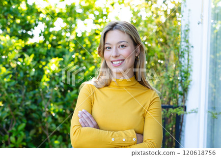 Happy caucasian woman standing on balcony and looking on camera, copy space 120618756