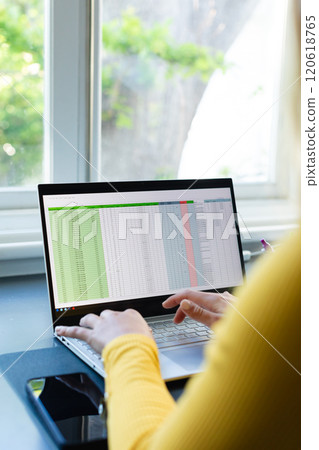Hands of caucasian woman sitting at desk, working from home and using laptop in sunny room Hands of caucasian woman sitting at desk, working from home and using laptop in sunny room 120618765