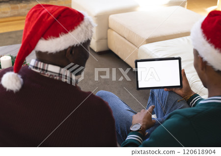 African american father and son having christmas tablet video call, copy space screen African american father and son having christmas tablet video call, copy space screen 120618904