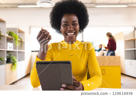 Portrait of happy african american casual businesswoman having video call in creative office Portrait of happy african american casual businesswoman having video call in creative office 120618936