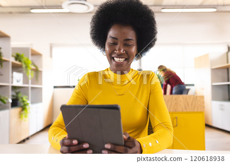 Happy african american casual businesswoman using tablet and having video call in creative office Happy african american casual businesswoman using tablet and having video call in creative office 120618938