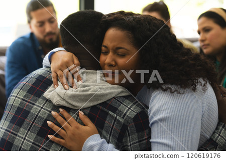 Two african american male and female friends hugging on therapy session Two african american male and female friends hugging on therapy session 120619176